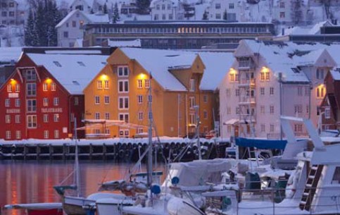 Tromso is situated on the island and is surrounded by fjords, mountains, islands. Local residents are proud of the most northern university and botanical garden, breweries